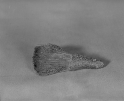 Private Collection. Object: Miwok soaproot brush. Dimensions: 6 1/2". Materials: Soaproot fiber, unidentified cordage, pine pitch. Technology: Pitch was apparently worked into fibers in handle rather than just smeared on. Collection History: Purchased from Mrs. Mary Longfellow Poncho (Maggie Longfellow Antoninni's mother). Photographed by Michael Dixon. Catalogued by Craig Bates and Barbara Beroza. Yosemite Collections, National Park Service.