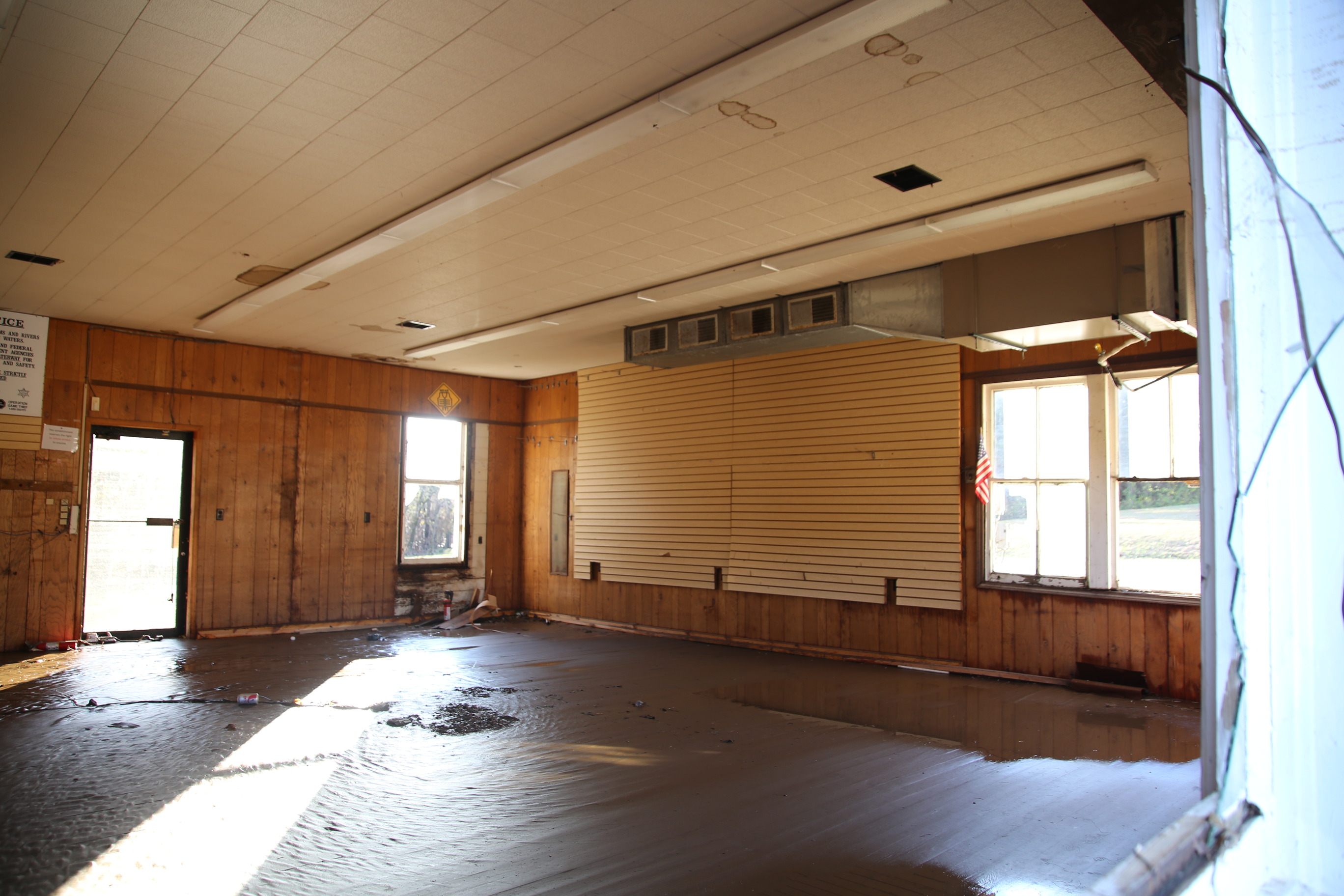Mud and water cover the floor of a store building.