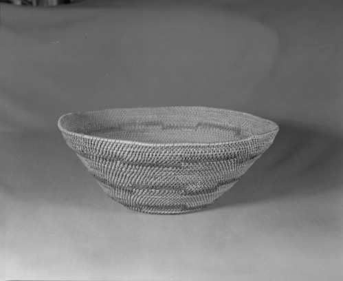 Private Collection. Object: Miwok basket. Dimensions: 13 1/2 x 5 1/4". Materials: Bracken fern root, split bull pine shoots. Technology: Single rod, interlocking stitch, most fag ends trimmed on work face, a few tucked under previous stitch; moving ends trimmed on interior. Rim stitched around once. Collection History: Purchased May 26, 1967 in Ahwahnee Gift Shop, formerly in collection of Supt. John C. Preston. Photographed by Michael Dixon. Catalogued by Craig Bates and Barbara Beroza. Yosemite Collections, National Park Service.