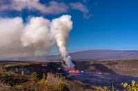 Several fountains of lava erupting from within a crater producing a large gas plume with Maunaloa volcano in a distance. 