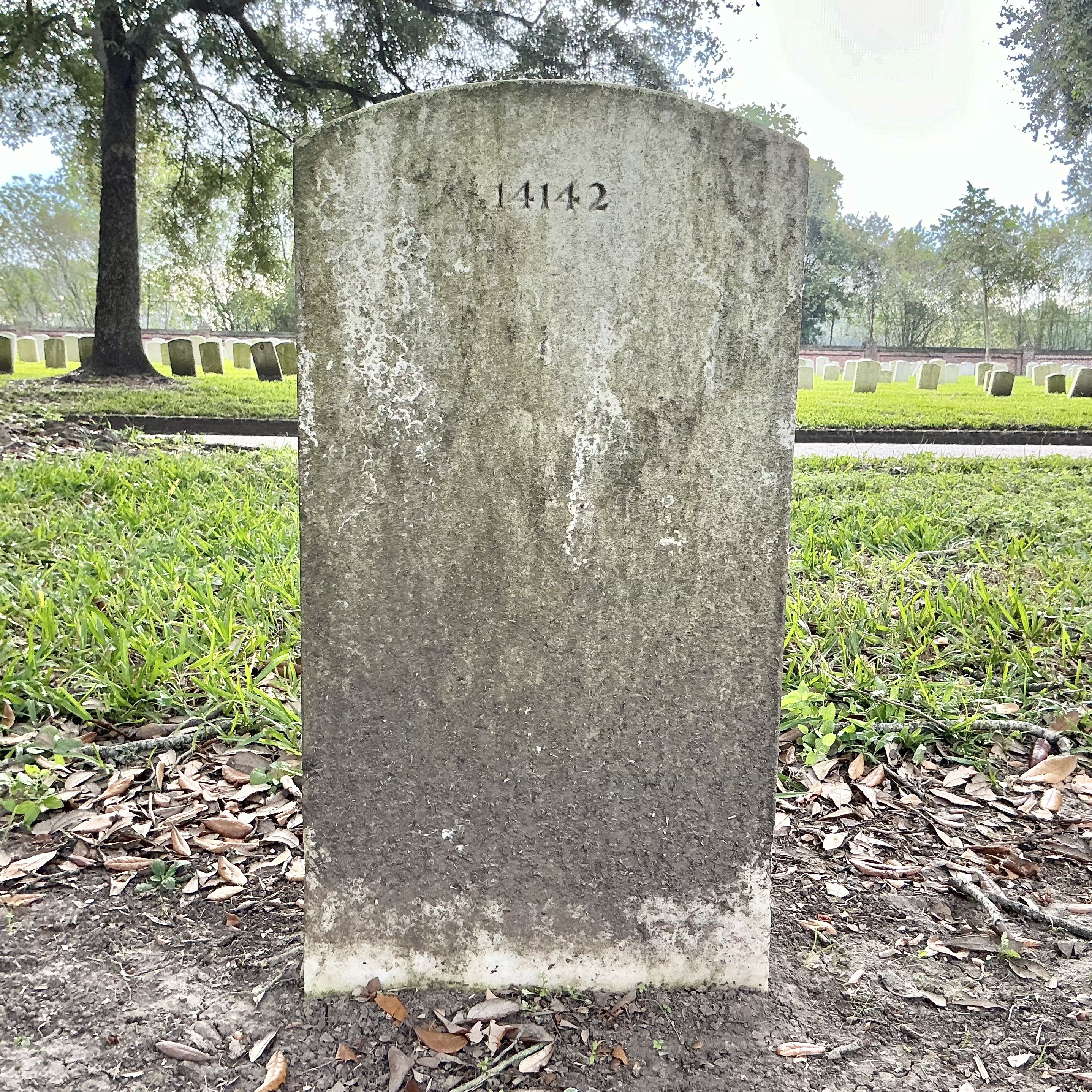 Back of upright marble headstone with flat face.