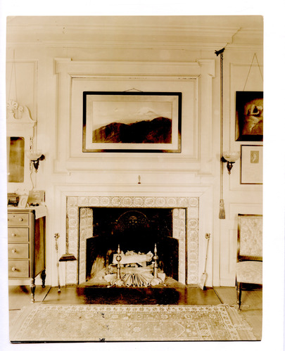 Black and white photograph of fireplace in 19th century bedroom.