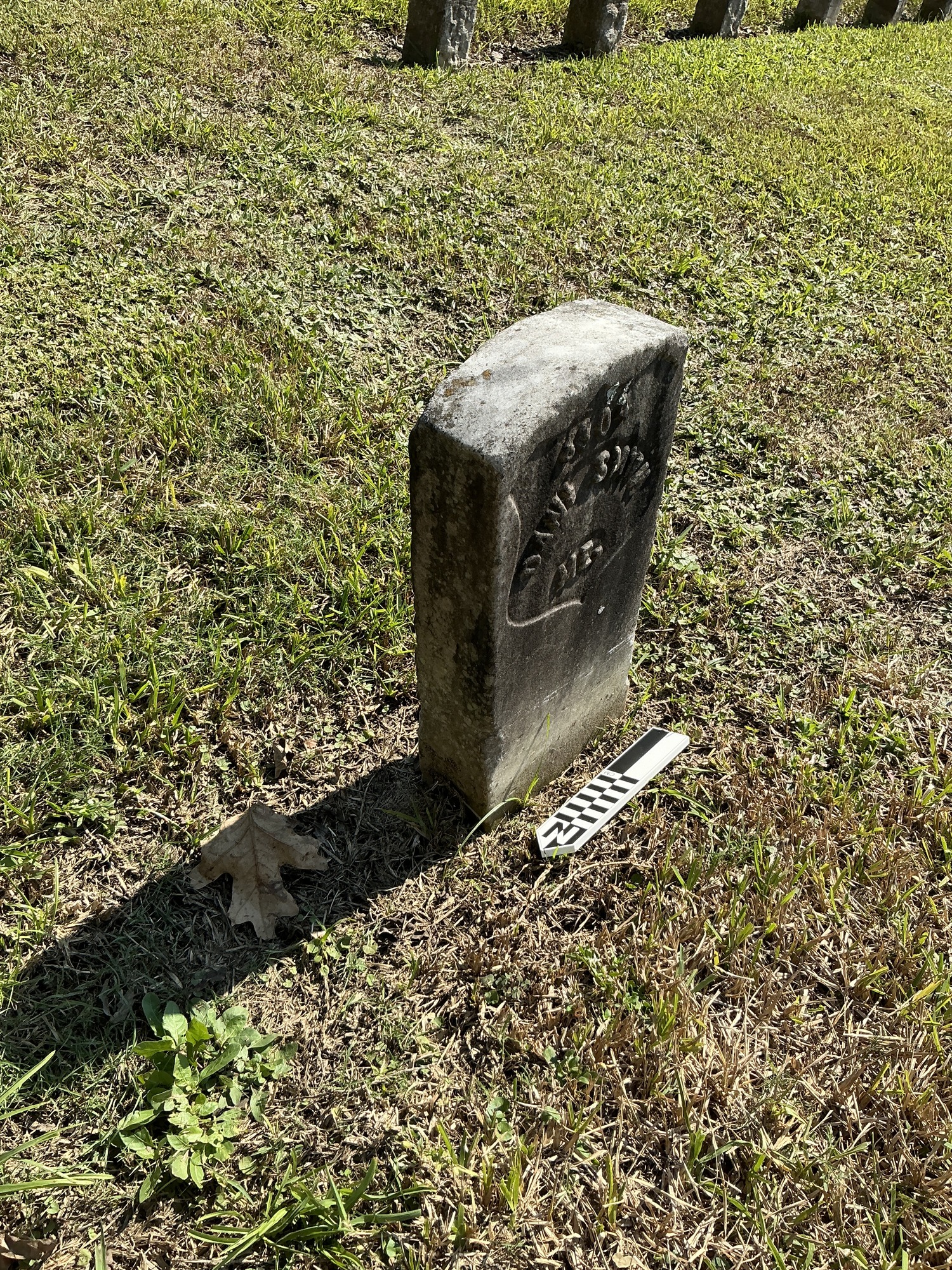 Extra image of historic upright marble headstone with recessed shield face.