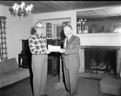 Superintendent Oberhansley presents award for meritorious service to Arden Schieffer at his retirement party. Party held at the ranger dormitory.