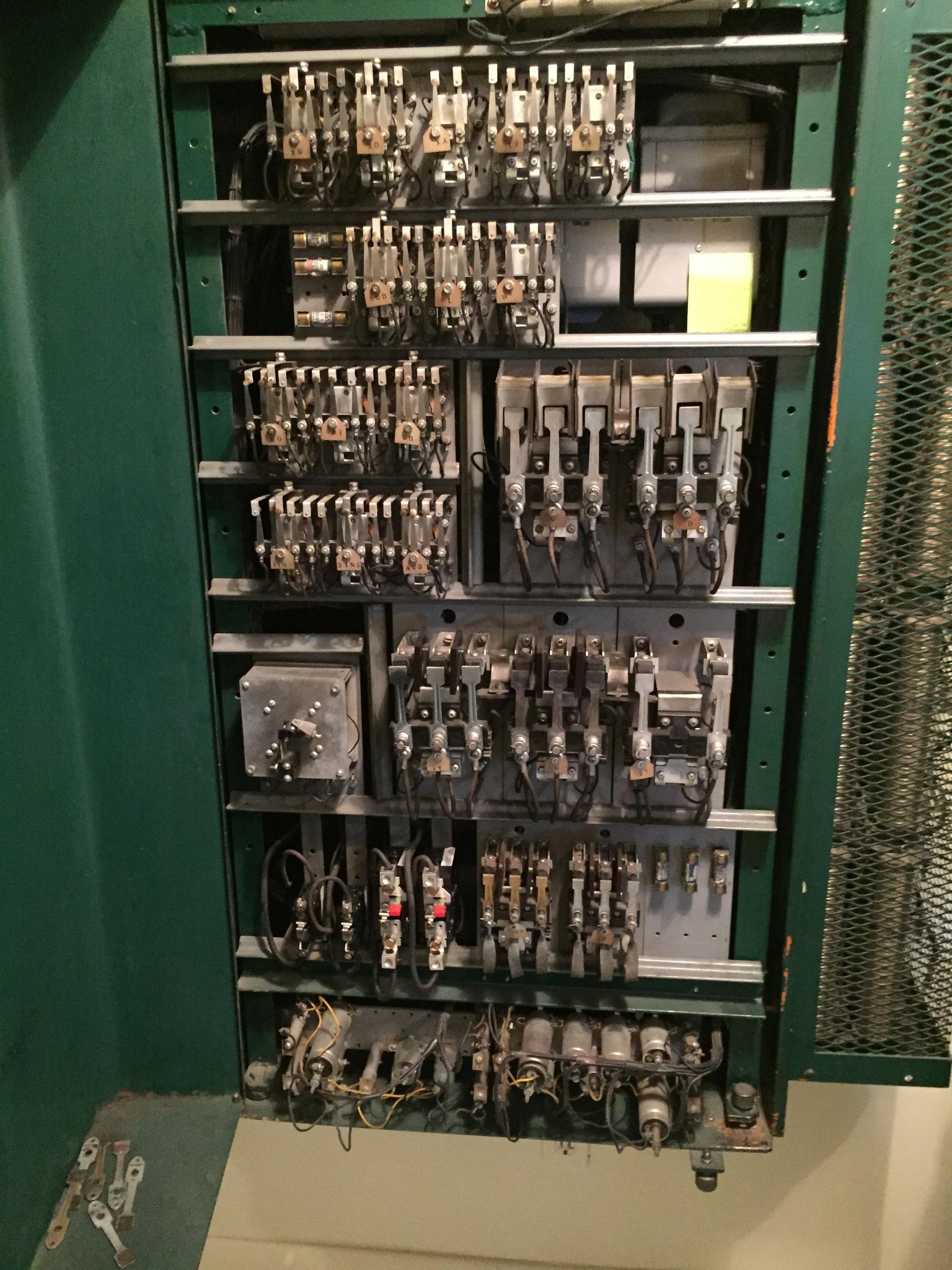 Green electrical box with circuits and switches inside it