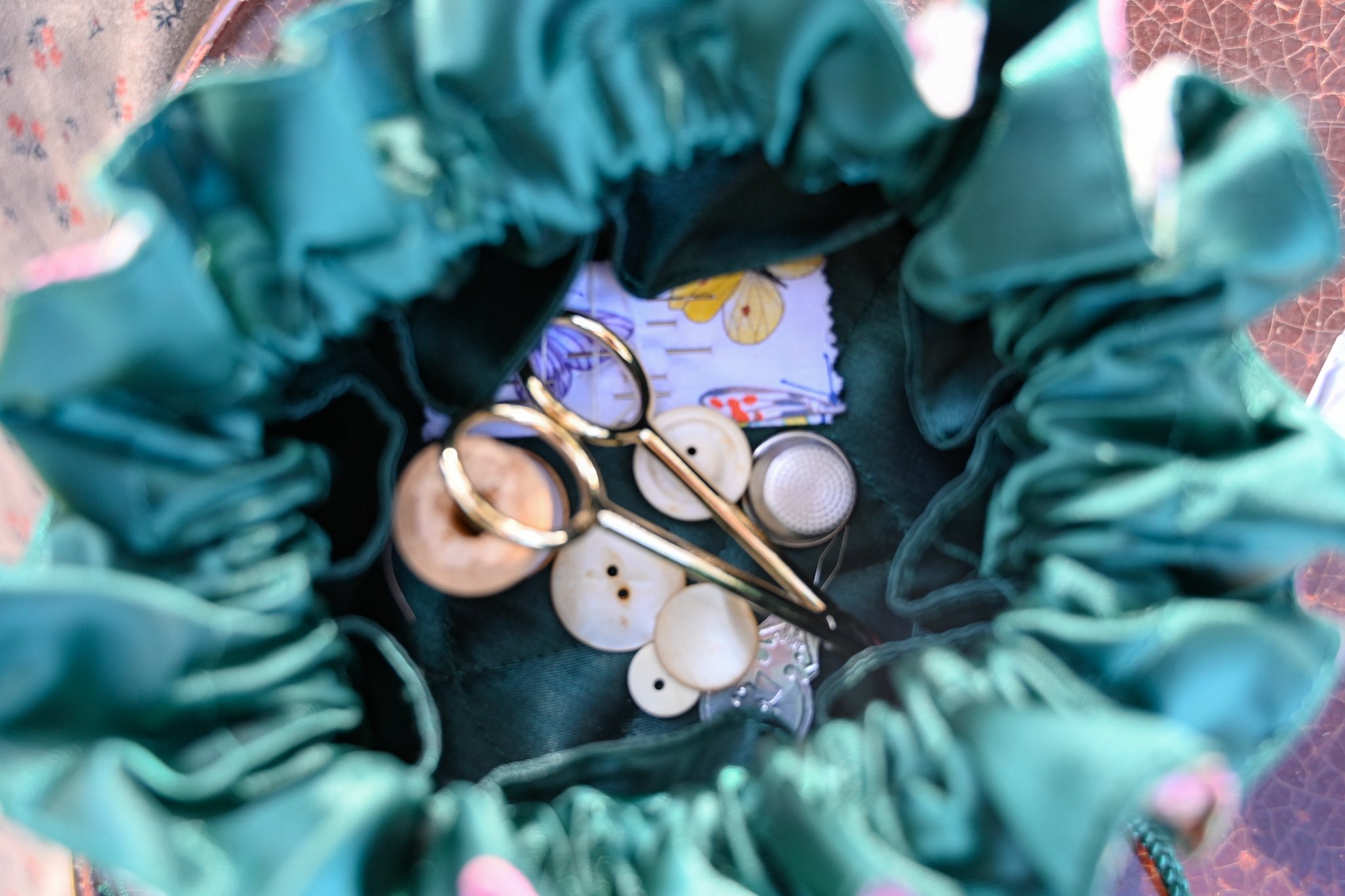 A look inside of the Women of Andersonville's sewing bags with button and lace scissors.