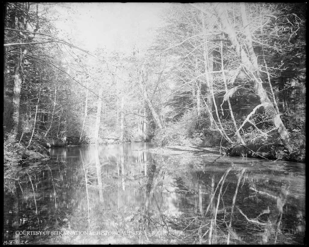 An outdoor portrait of Adolph Thomsen, wearing a hat, tie and three-piece suit. 