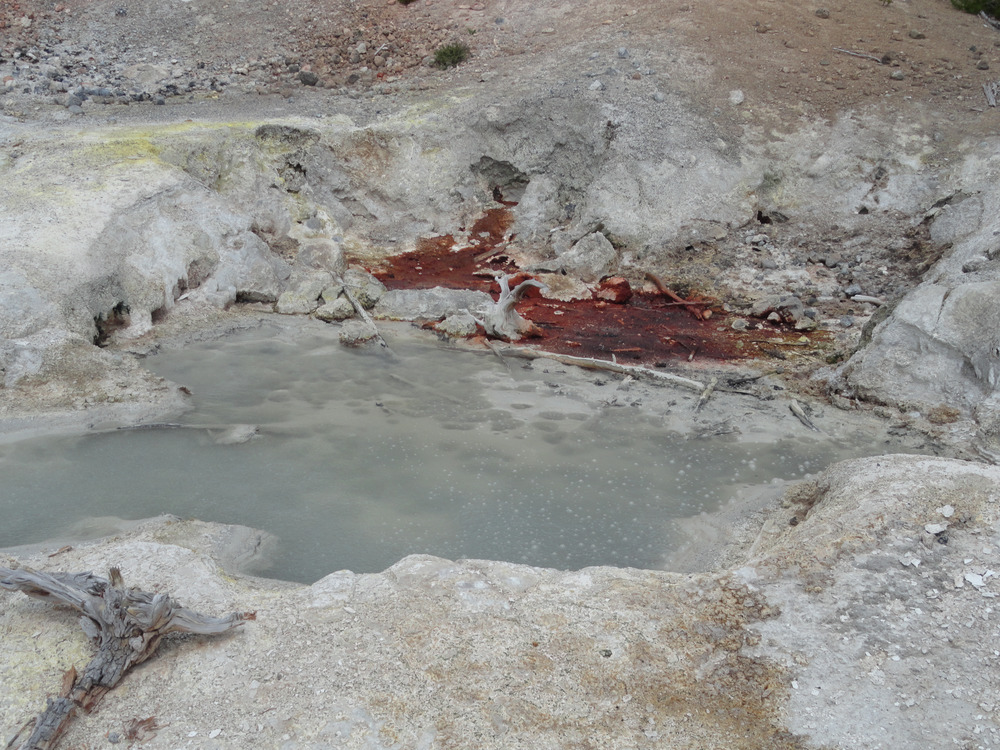 Milky blue pool surrounded by a white, barren landscape.