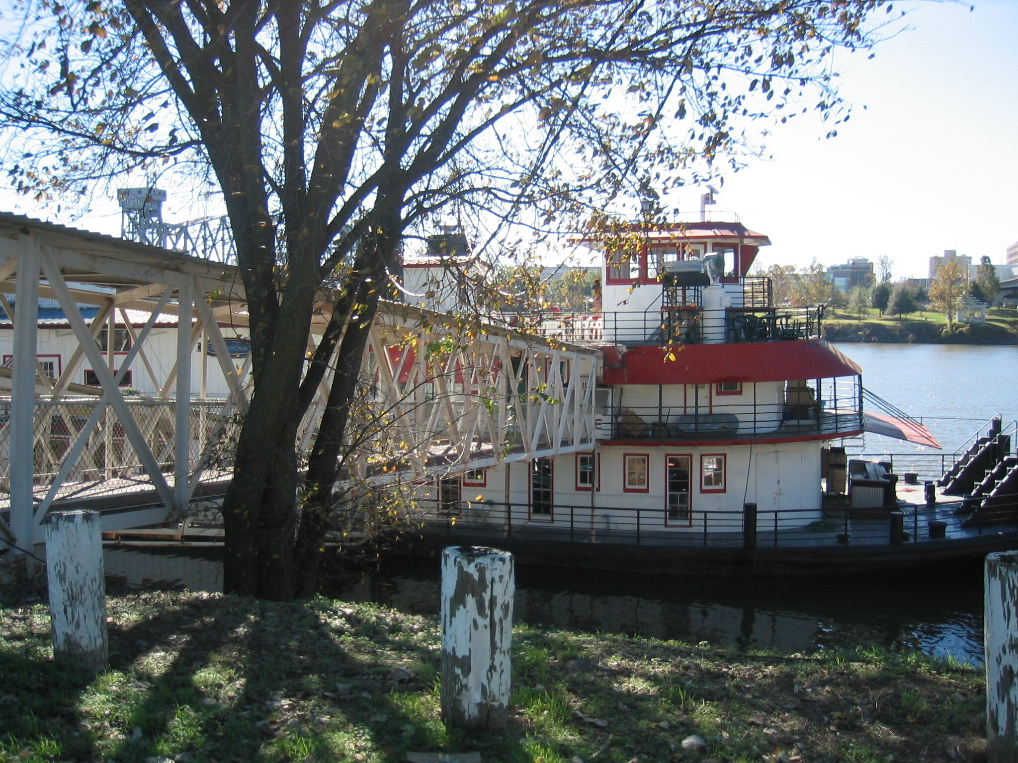 A bridge over a body of water with a boat on it.