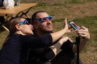 Visitors watch the partial eclipse at the National Mall and Memorial Parks
