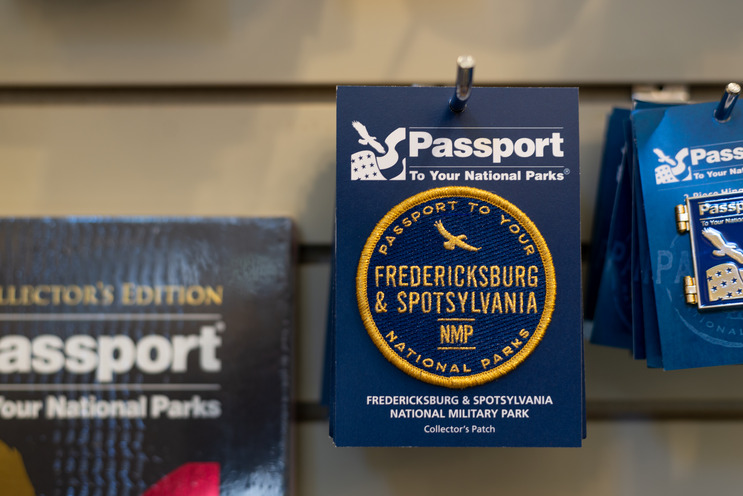 Close up of items in a gift shop with National Park Service Passport logo on them.