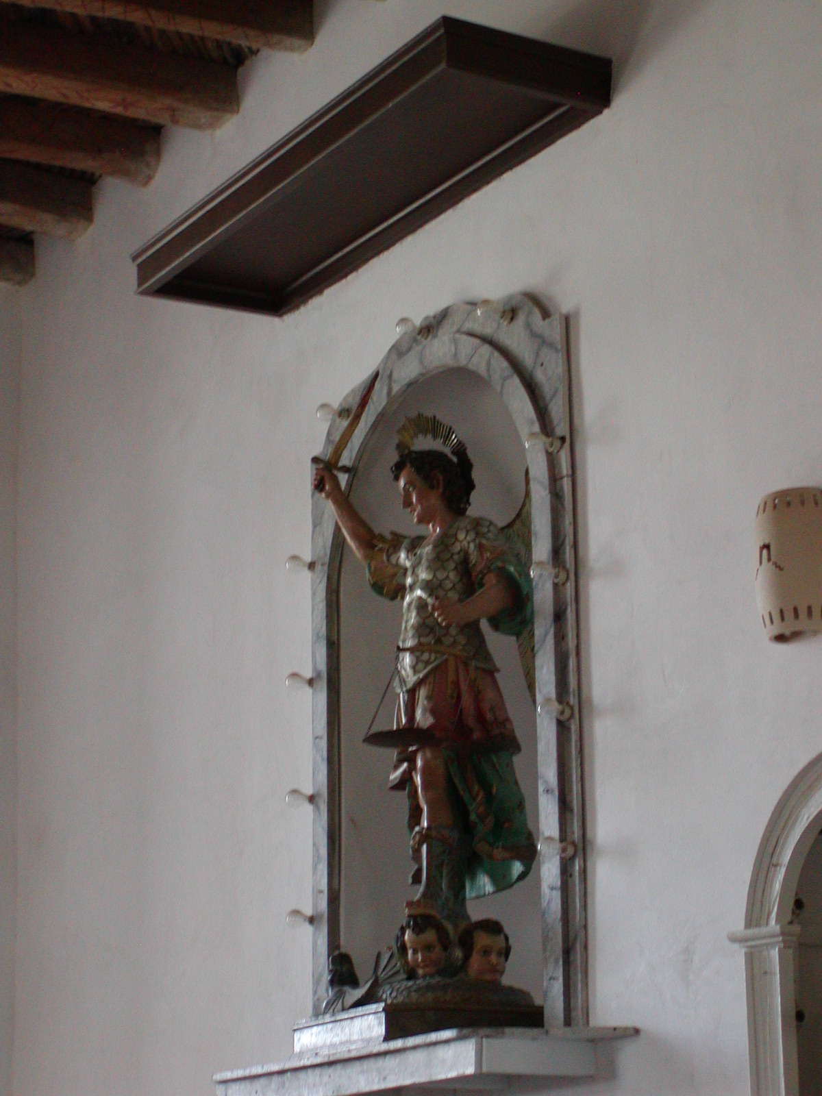 Ornamental statues line the walls at the Socorro Mission in Socorro, TX