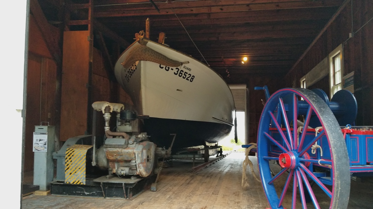 Many lifeboat stations were assigned the venerable thirty-six foot self-righting motor lifeboat as the primary rescue craft. CG 36528 was assigned to Grand Marais with a crew of four. These boats had a two ton keel which would right them in heavy waves. Divided into three sealable compartments, they could hold a total of 40 people including crew. The motor lifeboats were constructed in Curtis Bay, Maryland and were used for many years on both coasts and the Great Lakes. CG 36528 is now on display in the boathouse at Sand Point, which once served as the Munising motor lifeboat station. A big spoked-wheel wooden cart that could be pulled across sand is visible.