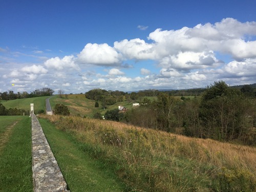 dramatic sky fields stone wall