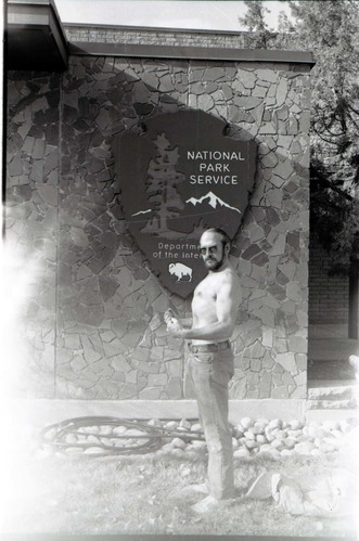 BW Photos of Interpretation Personnel. Man with beard flexing muscles.
