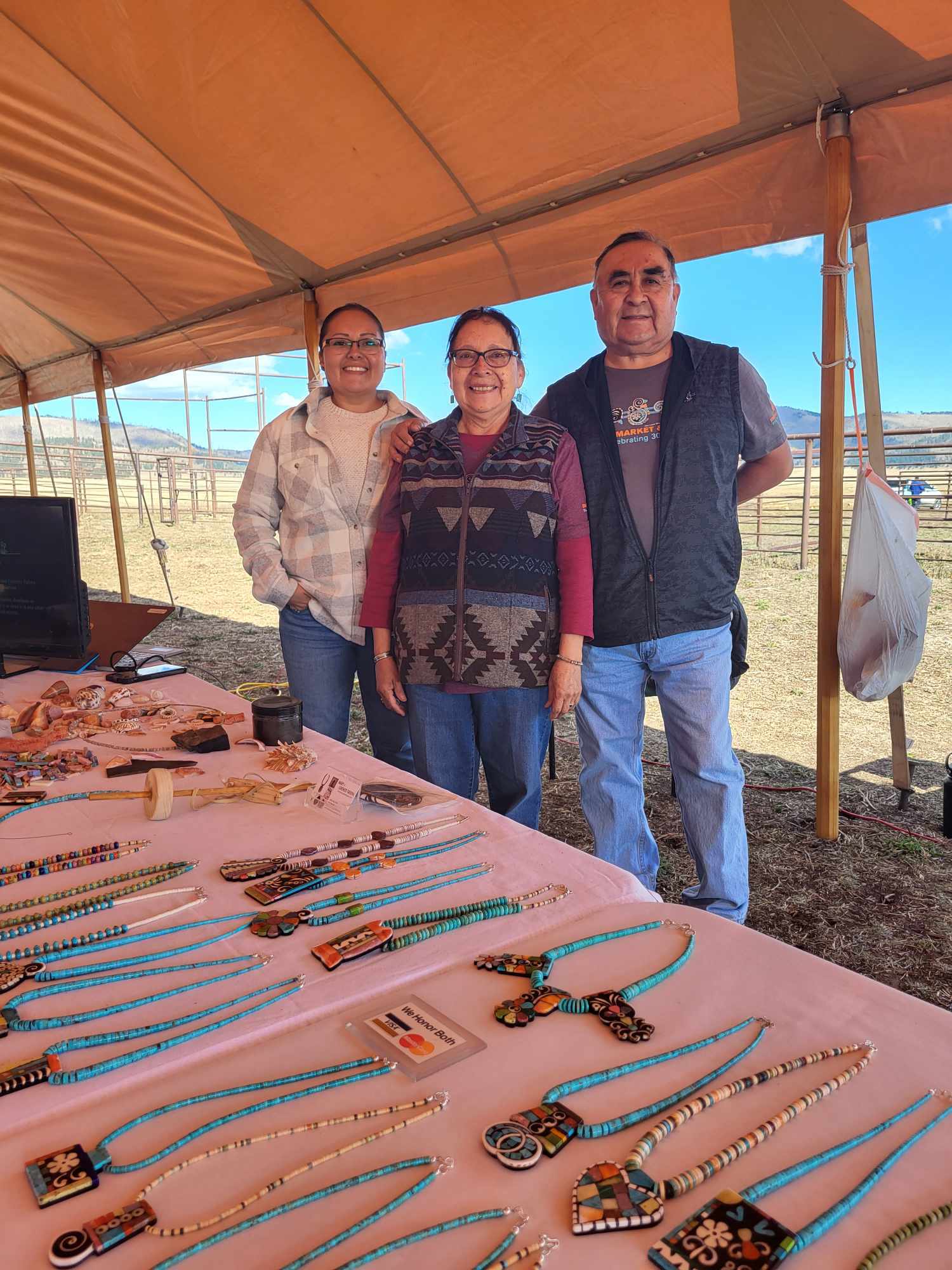 A family of local artists smiles at us from their outdoor booth.