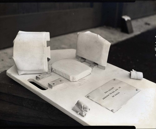 Special apparatus for stretcher for first-aid in neck injuries designed by Rudy Lueck.