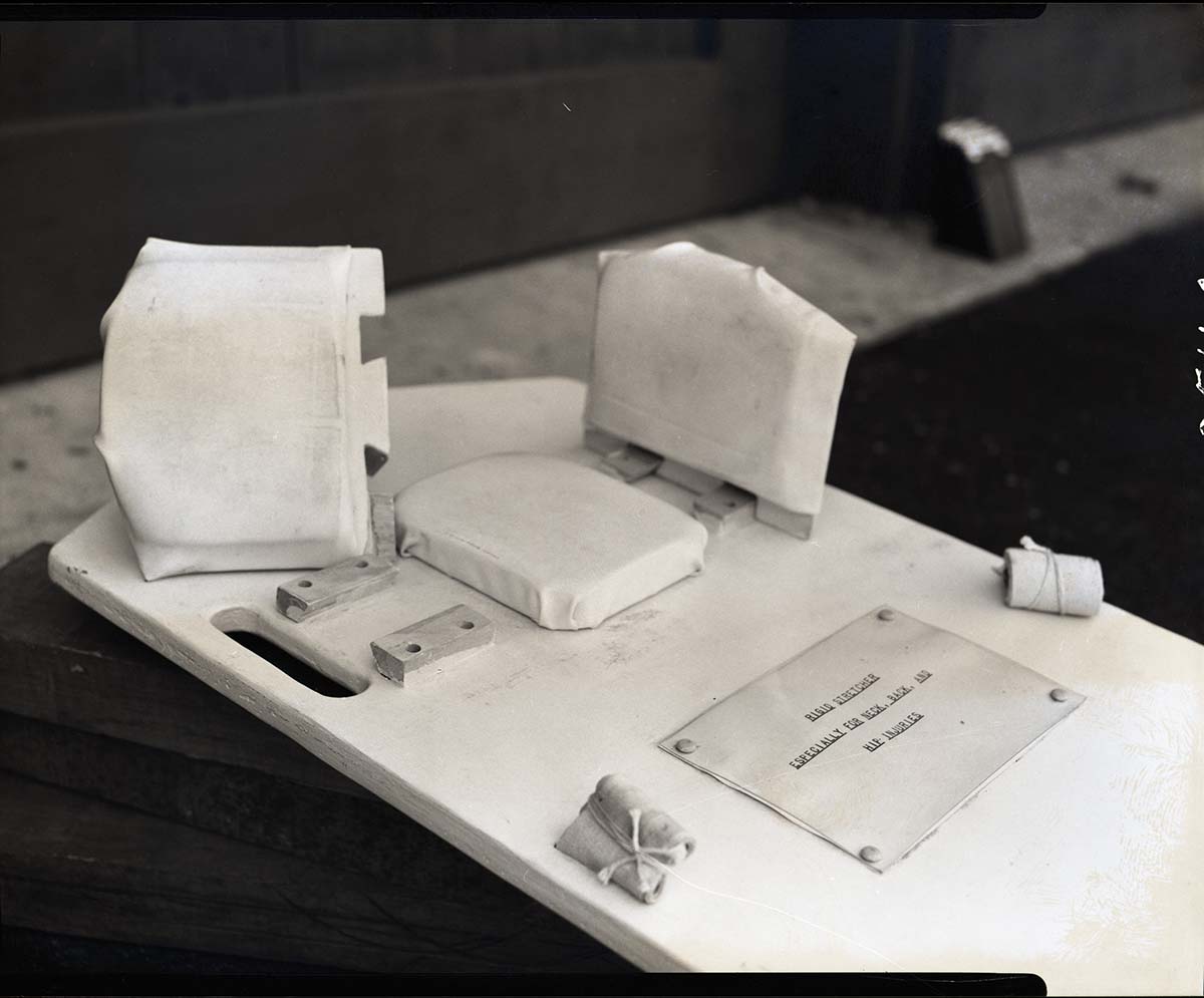 Special apparatus for stretcher for first-aid in neck injuries designed by Rudy Lueck.