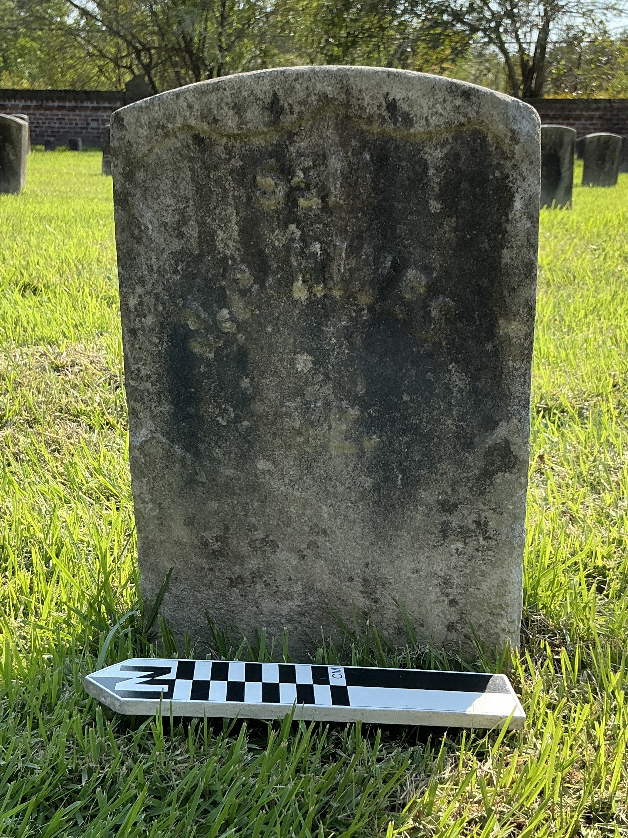 Extra image of historic upright marble headstone with recessed shield face.