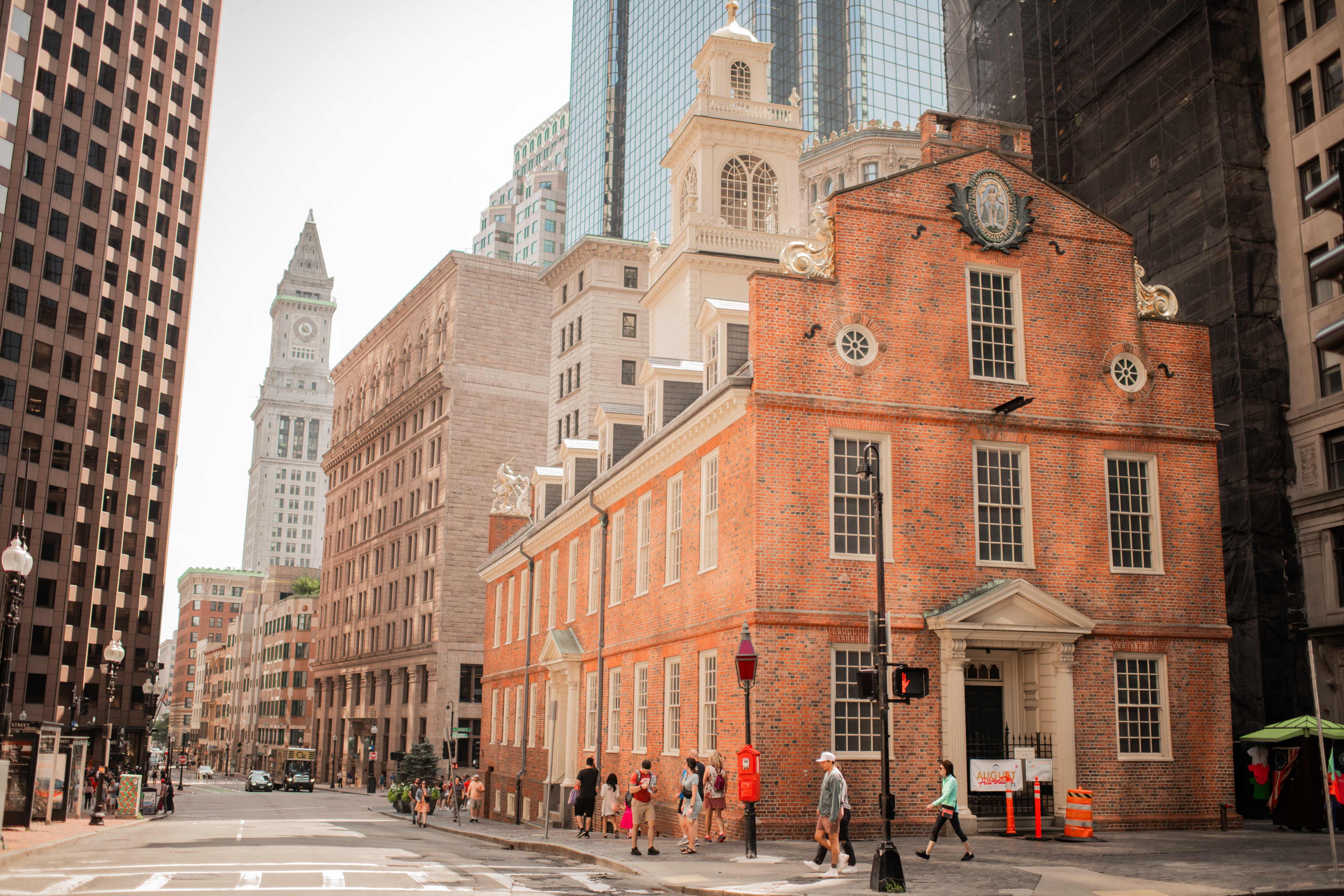 Old State House, a red brick building, with the Boston Customs House in the background. 