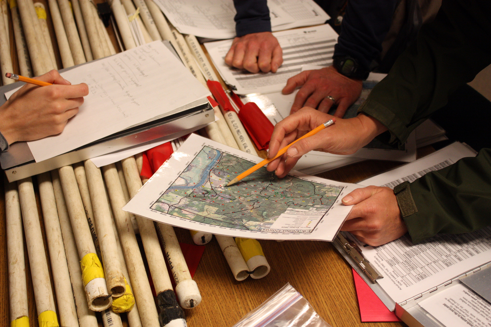 Rangers examine a map of the Lewis and Clark NHP forest