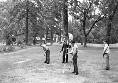 Sailors playing golf, Ahwahnee as Naval Hospital in background.