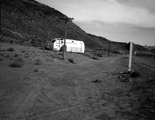 Signs and junk at 101 Ranch, along State Route 15 (now State Route 9), approach road to Zion. Materials retrieved from United States Air Force (USAF) Hurricane Supersonic Research Site on Hurricane Mesa, Coleman Engineering Company.