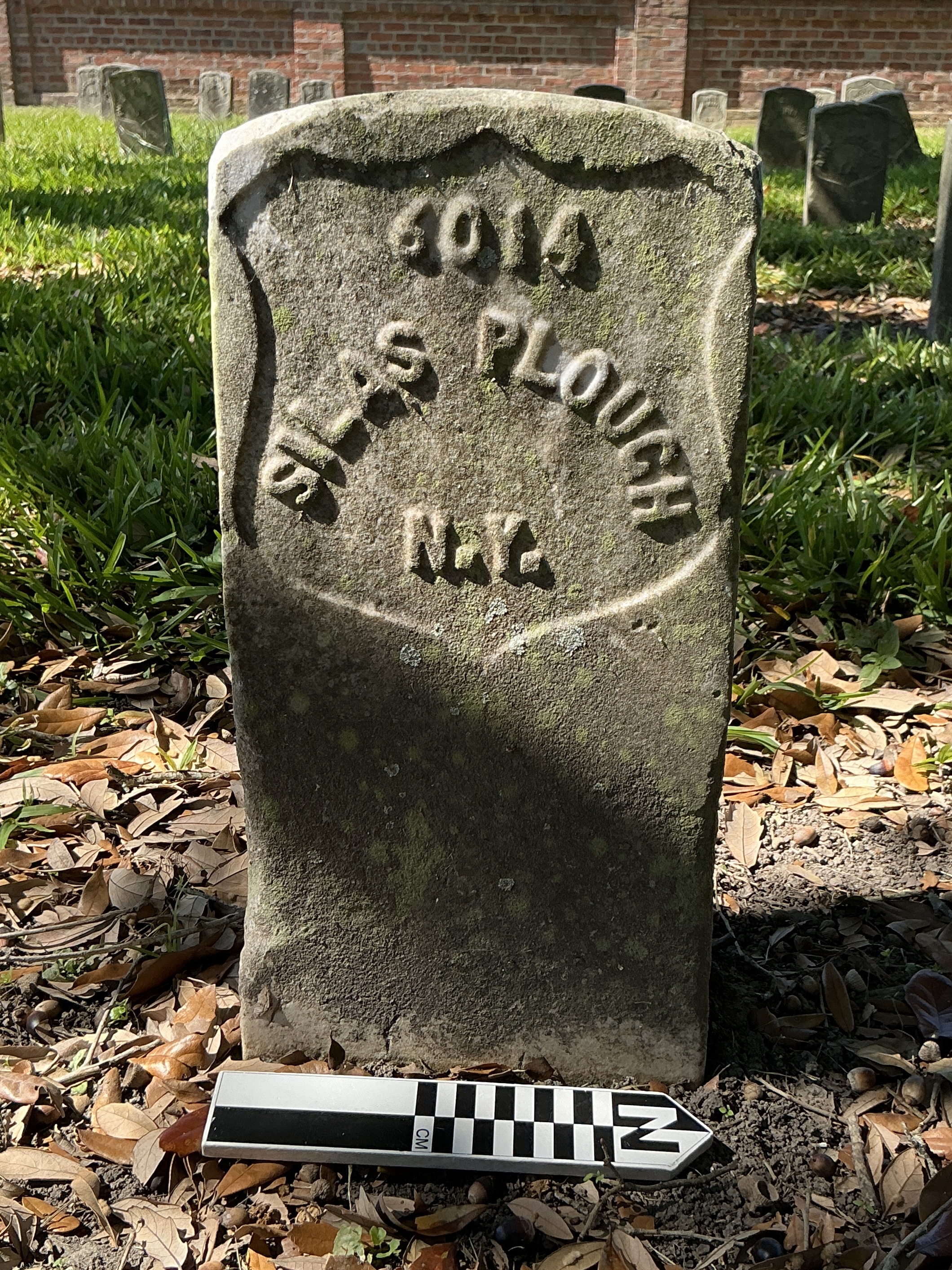 Extra image of historic upright marble headstone with recessed shield face.