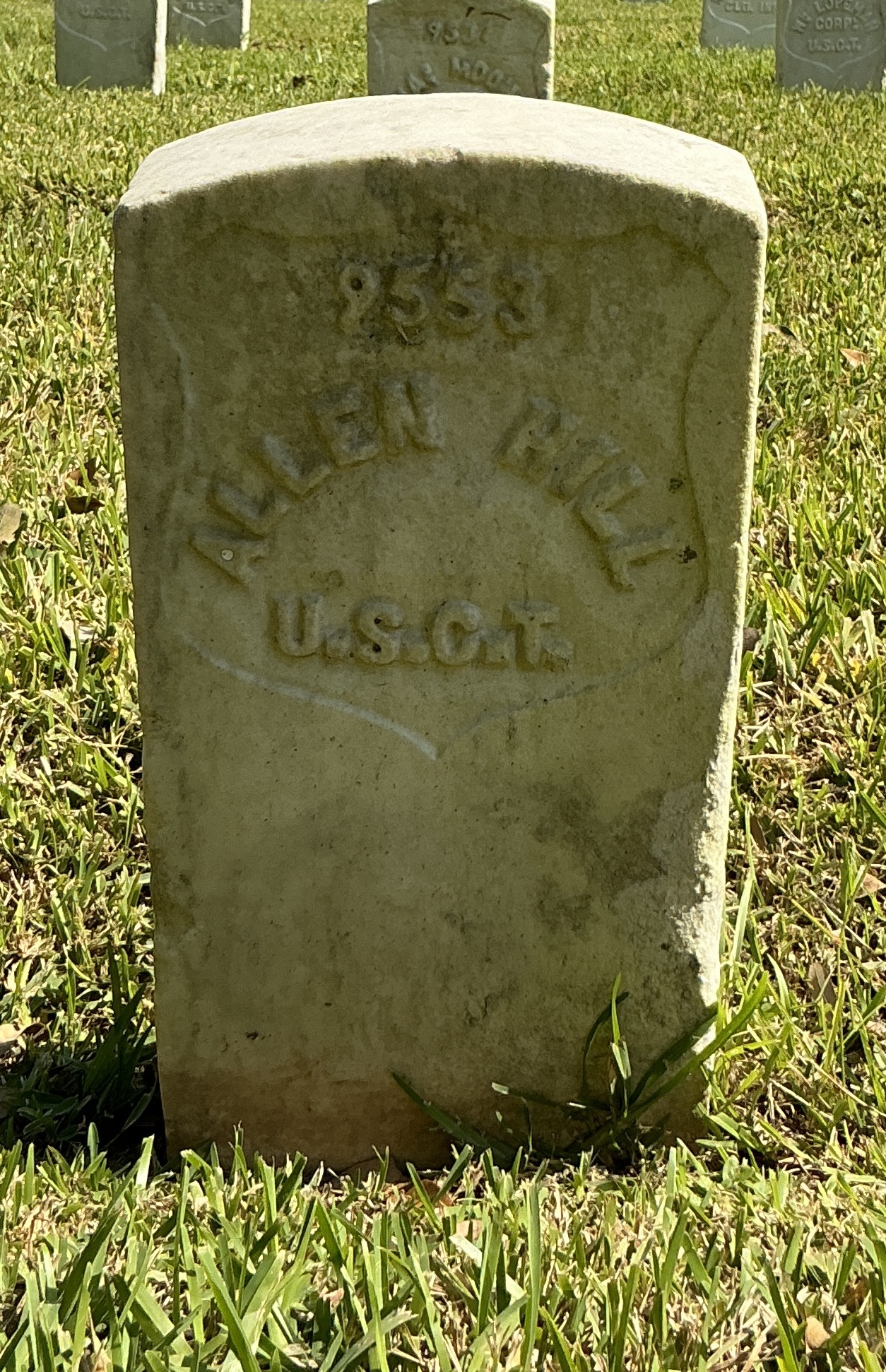Front of historic upright marble headstone with recessed shield face.