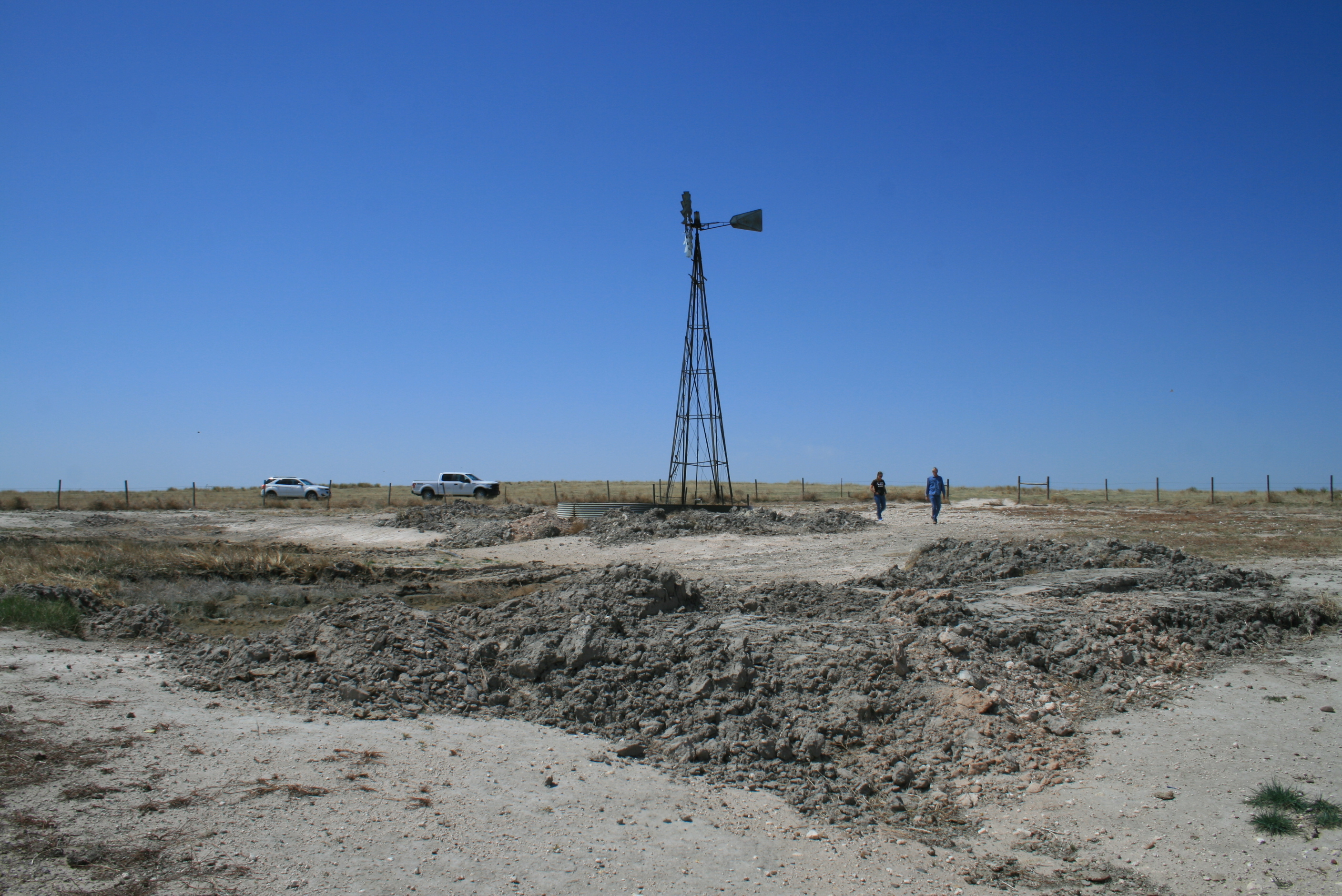 A windmill in the middle of a field.