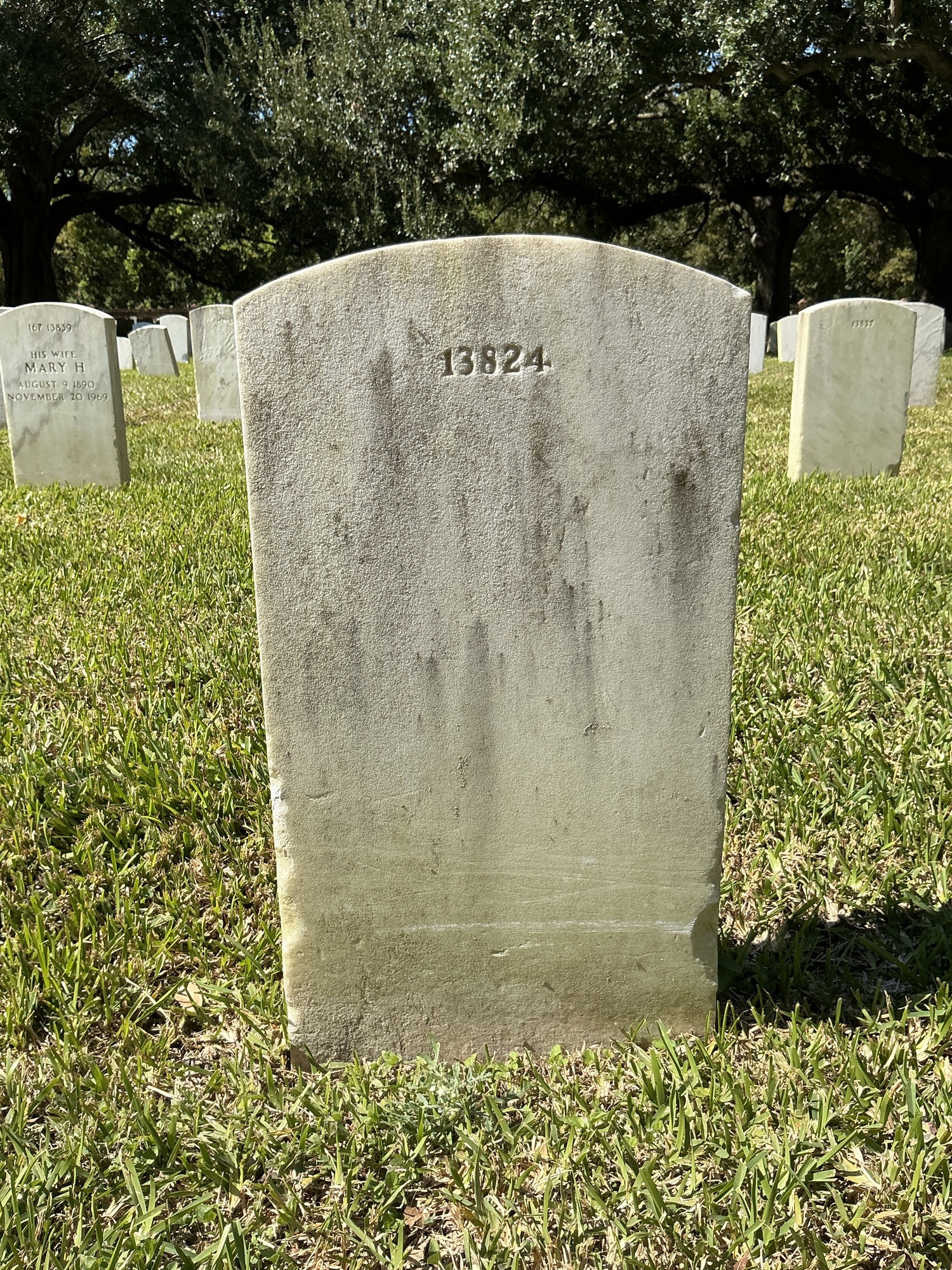 Back of upright marble headstone with flat face.