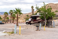 RV, trees, picnic bench and power and water hook ups