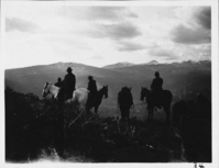 W.P. Railroad Officials on Horseback. Arthur G. Holmes Collection: Album 1. President H.M. Adams, engineer Phillips, guide Jim Kelly, and Merle Sager of Western Pacific Railroad on horseback overlooking Warner Valley.  1930, President H.M. Adams, engineer Phillips, guide Jim Kelly, and Merle Sager of Western Pacific Railroad on horseback overlooking Warner Valley