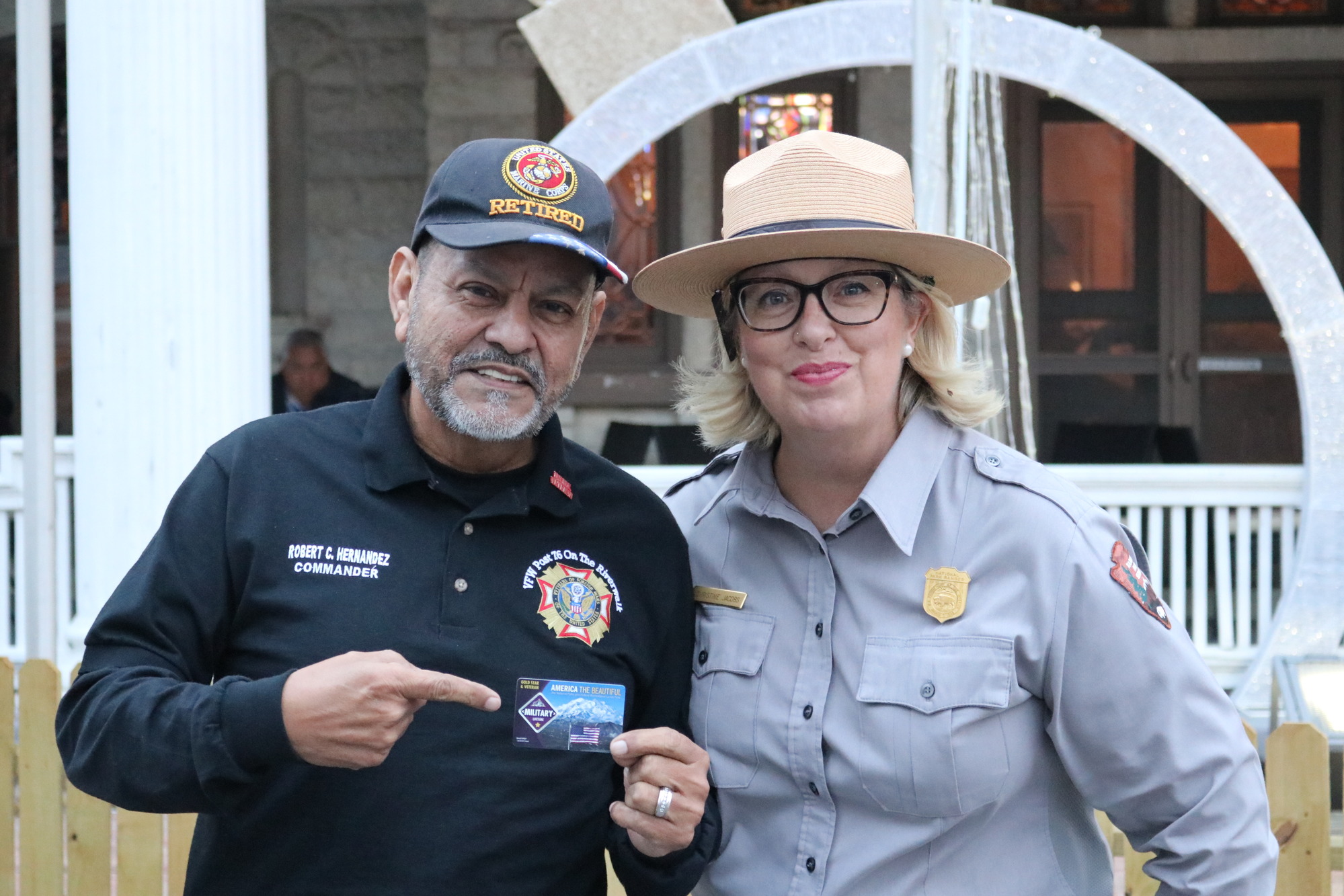 Veteran holding new military pass next to a park ranger.