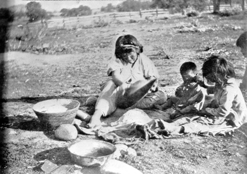 Sifting acorn meal -- separating the coarse particles by shaking. Copied from W.H. Holmes report U.S. National Museum, 1900 plate 12.