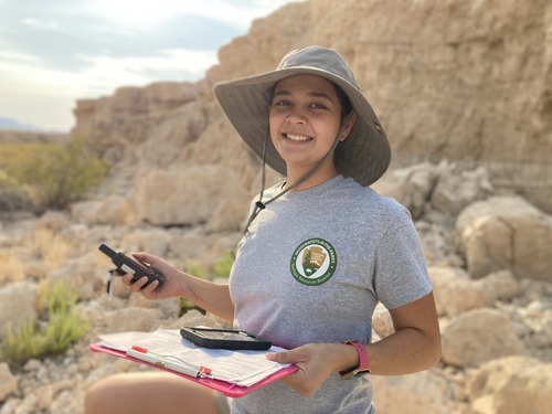 Woman holding equipment and clipboard