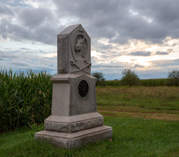A 10 foot tall rectangular stone monument with a horses head carved into the upper portion.