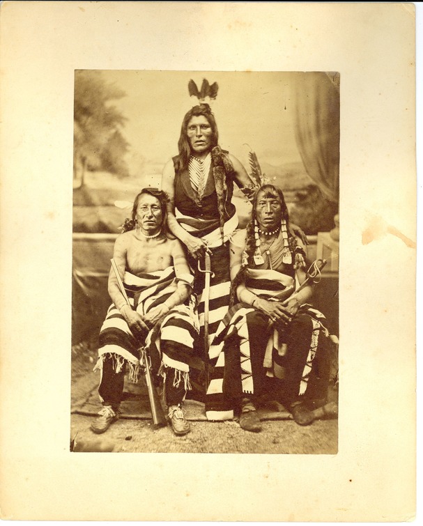 Three Sioux Warriors with U.S. Cavalry Sabers and a Sharp's Carbine