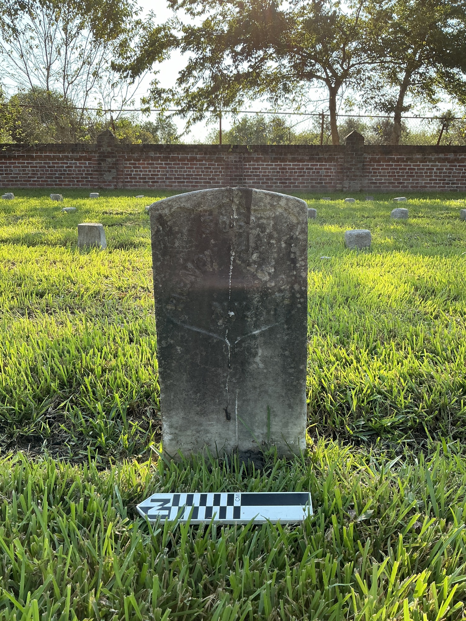 Extra image of historic upright marble headstone with recessed shield face.
