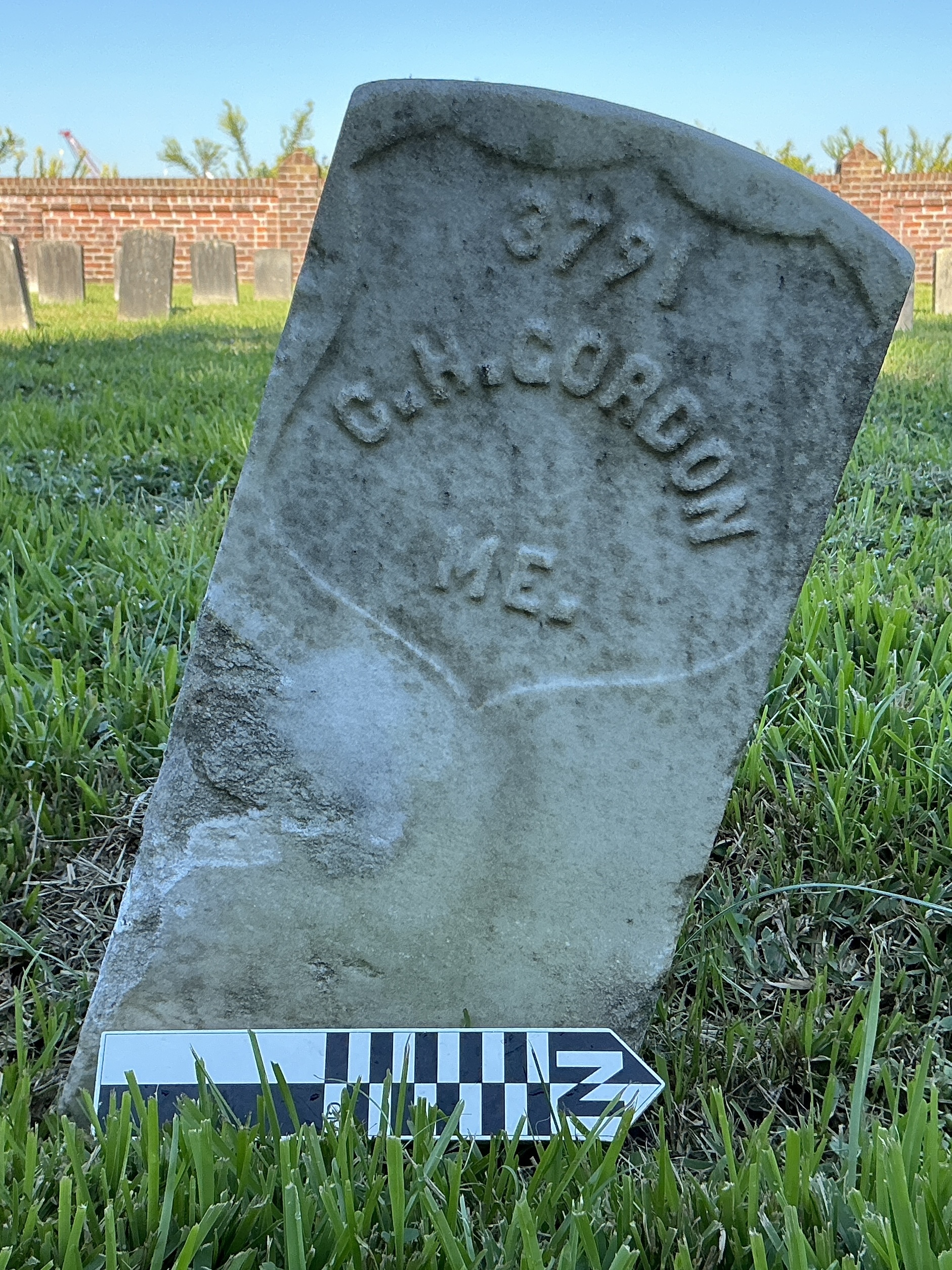 Extra image of historic upright marble headstone with recessed shield face.