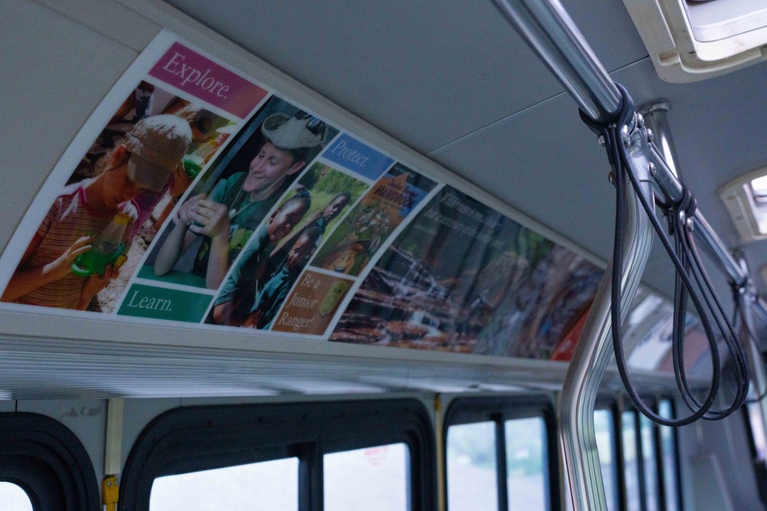 Close up photo of multiple signs that are on display inside the Zion shuttle buses above the windows.