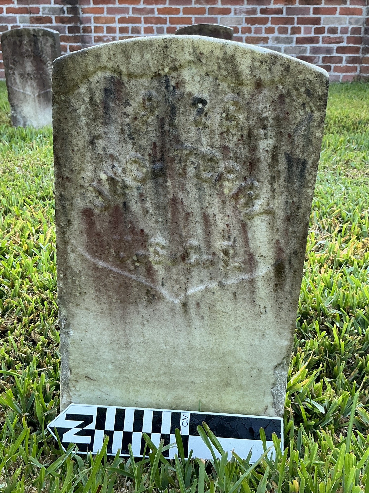 Extra image of historic upright marble headstone with recessed shield face.