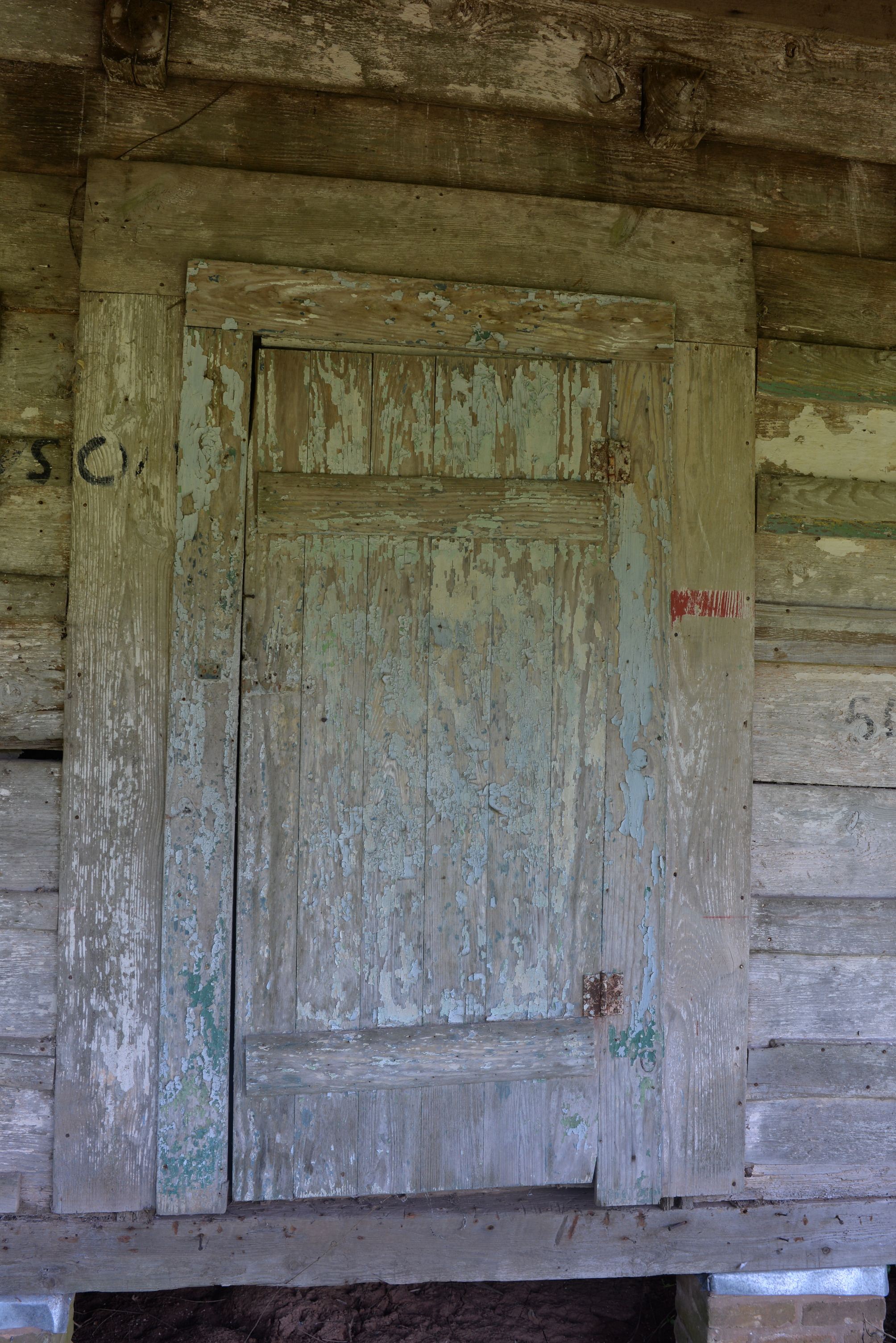 Close up of wooden front door to a wooden structure.
