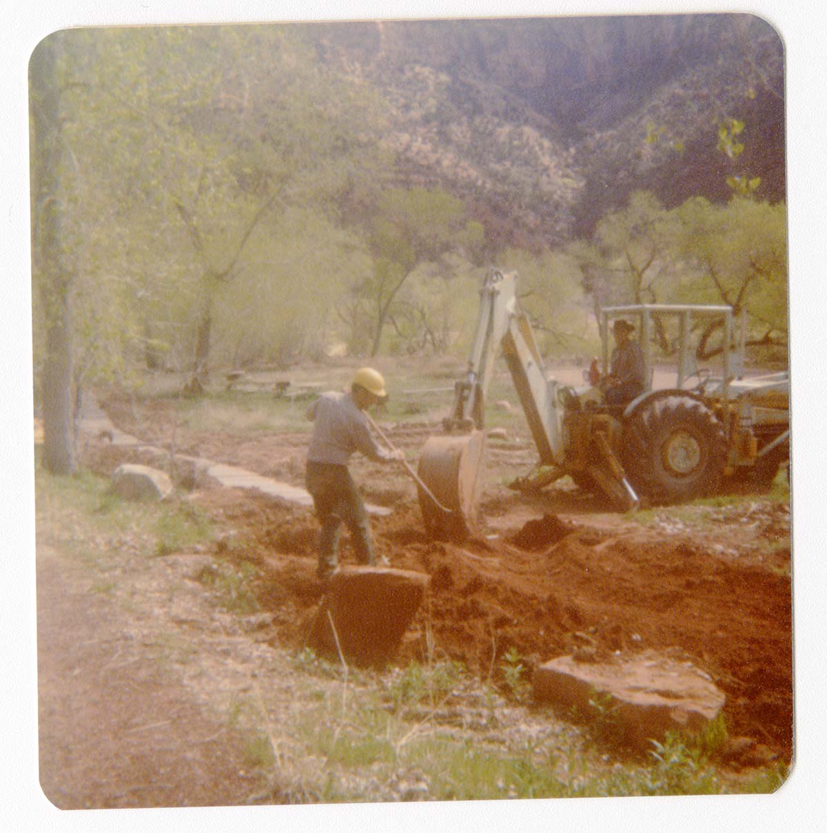 Excavator being used to assist in uncovering the irrigation ditch in South Campground.