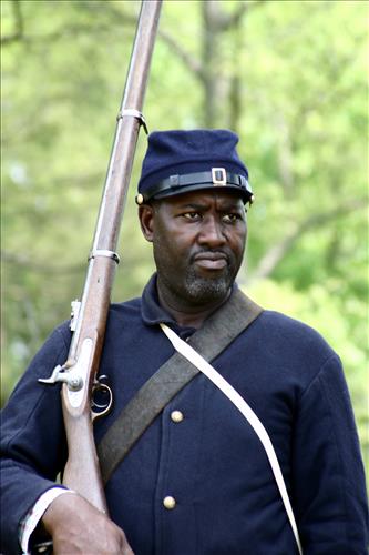 Portaits of Civil War interpreters of U.S. Colored Troops with their rifles at Stones River National Battlefield, April 2004