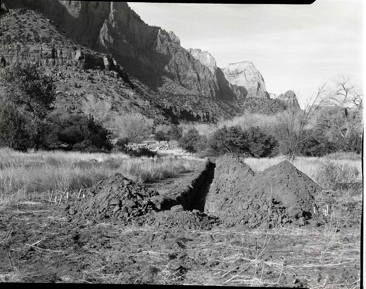 Visitor center sewage system with excavation of sewer line.