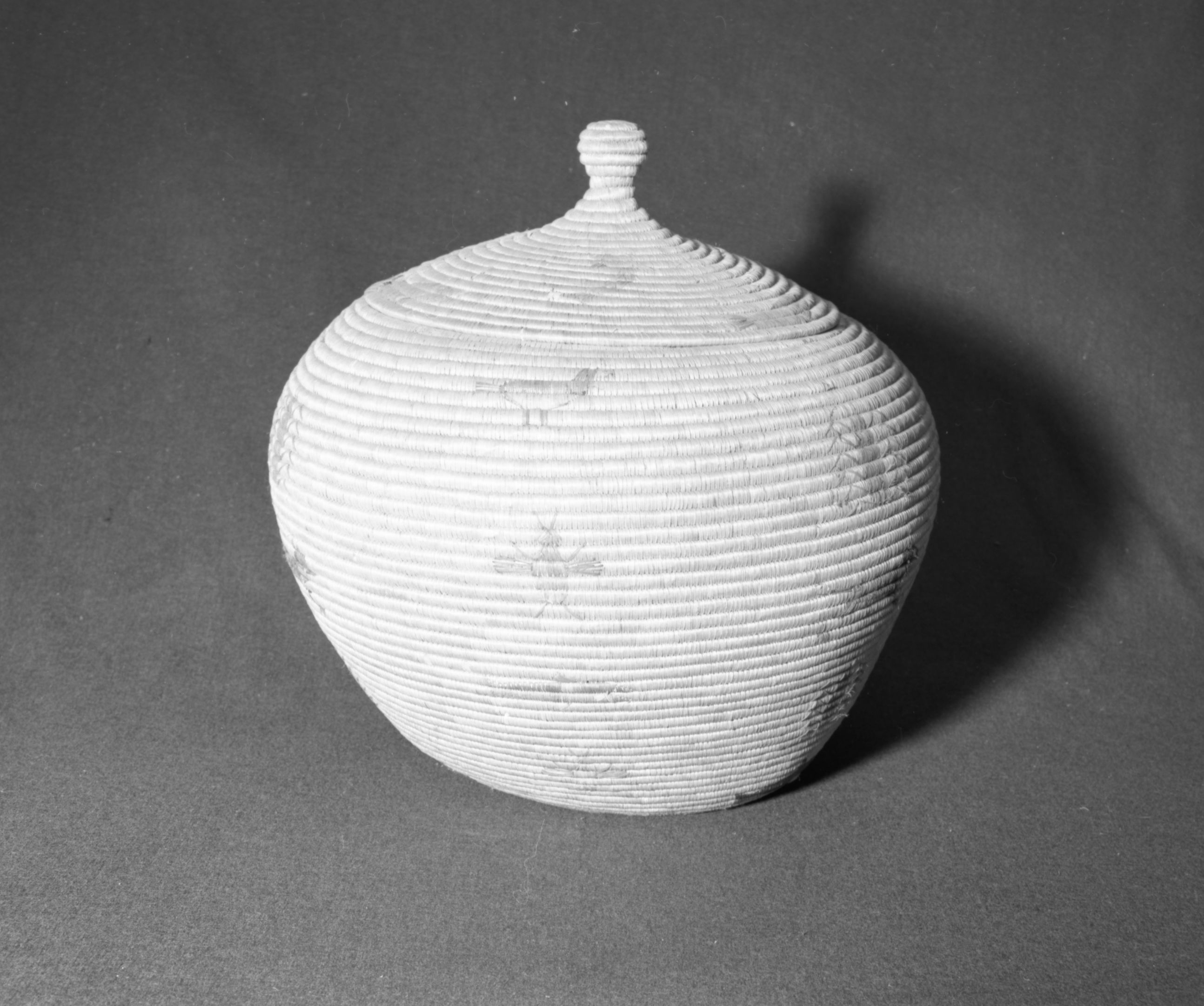 Marie Rozier Collection, Catalog No. 177. Object: Eskimo basket. Dimensions: 21 x 19". Materials: Seagrass, dyes. Technology: Coiled, rightward coil direction, pictorial designs of fish, seals, birds, insects, whales, and an unidentified mammal. Collection History: Acquired form Ora Doyle. Photographed by Michael Dixon in December 1982. Catalogued by Craig Bates and Barbara Beroza. Yosemite Collections, National Park Service.