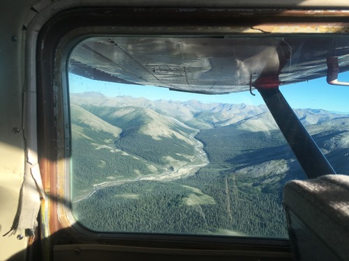 Mountains and streams out the window of a small airplane