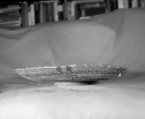 Private Collection. Object: Chumash basket. Dimensions: 16 x 3" (incl. base) Base 3/4" x 5". Materials: Right ward coil direction. Three rod juncus foundation. Technology: Possibly from George Wharton James collection sold by Dawson's Bookstore in Los Angeles, or from a private collection in Newhall. Photographed by Michael Dixon. Catalogued by Craig Bates and Barbara Beroza. Yosemite Collections, National Park Service.