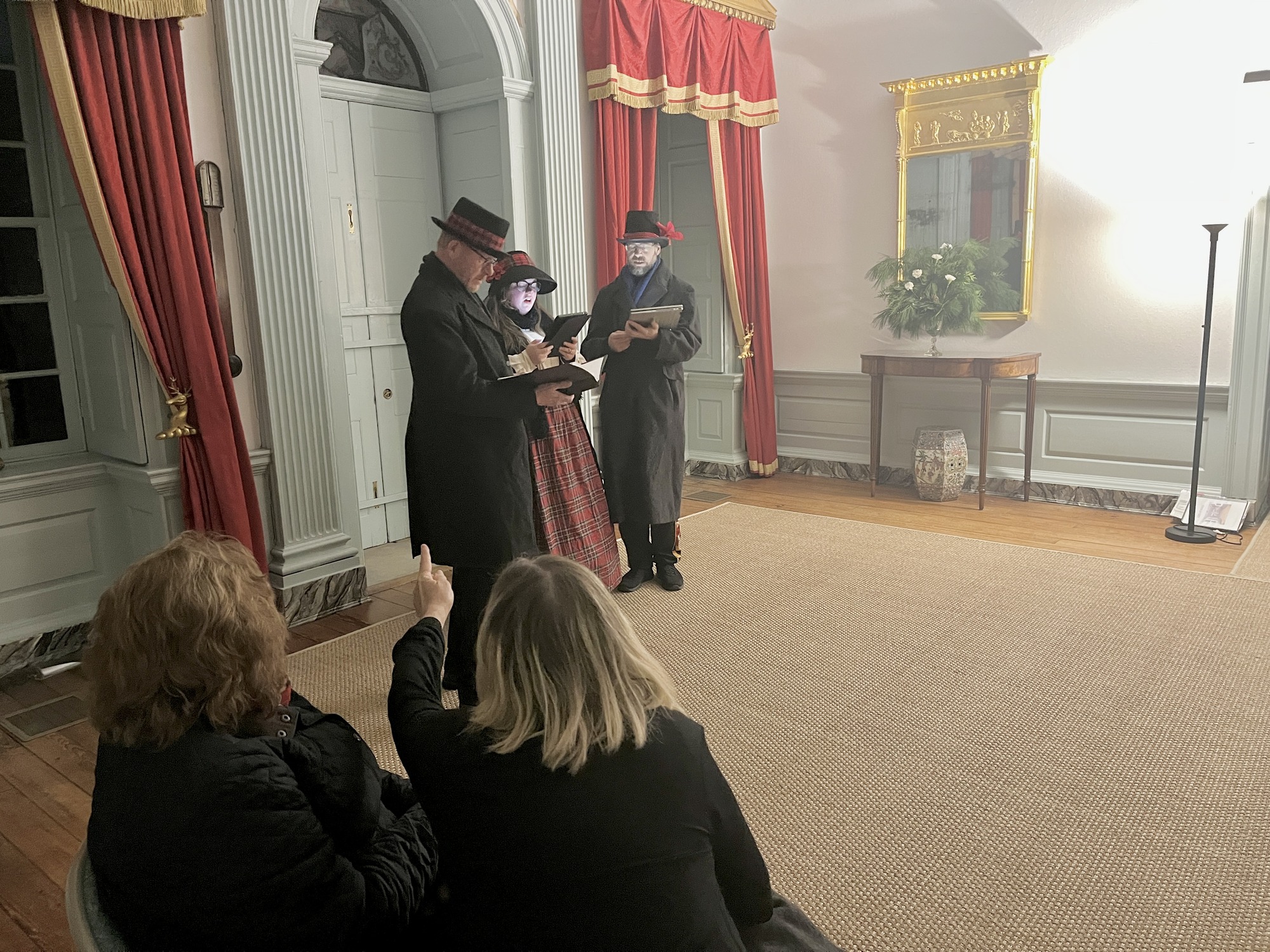 Visitors watching Caroling by 42nd Street Singers